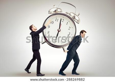 Businessman with arms raised catching something against grey background