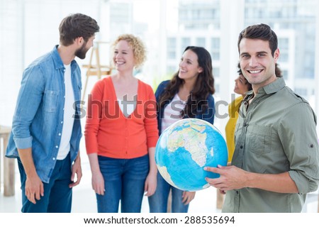 Young creative business people with a globe in the office