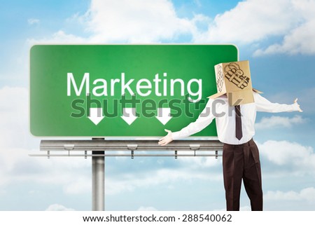 Anonymous businessman with arms out against signpost showing marketing direction