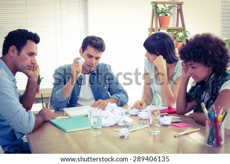 Exhausted business team making paper pellet at office