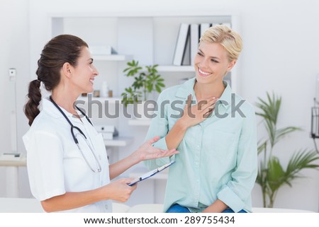 patient smiling to her doctor in medical office