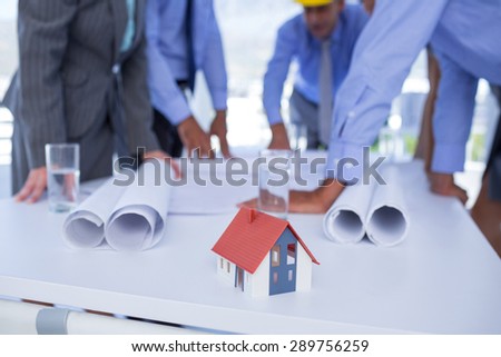 team of business people looking at construction plan in office