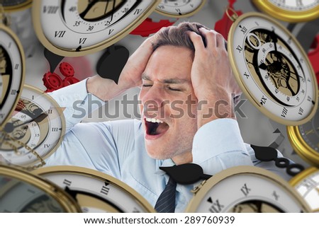 Stressed businessman with hands on head against grey vignette