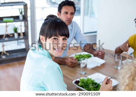 Young businesswoman having lunch with her colleagues