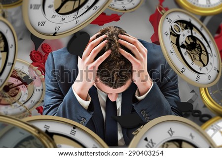 Businessman with head in hands against grey vignette
