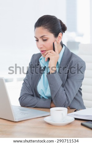 Concentrating businesswoman using her computer in her office