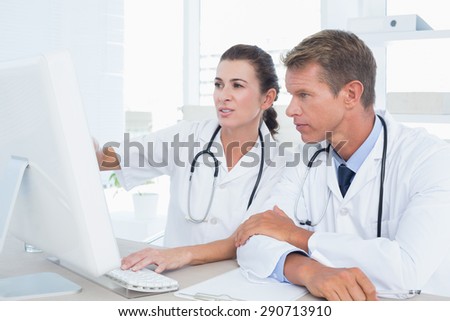 Concentrated doctors using computer in medical office