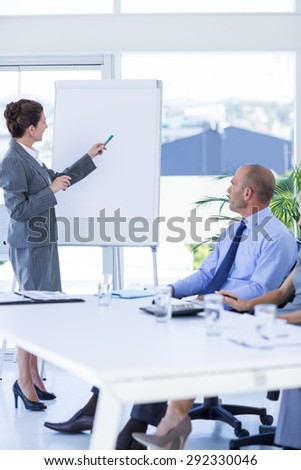 Business people looking at meeting board during conference in office