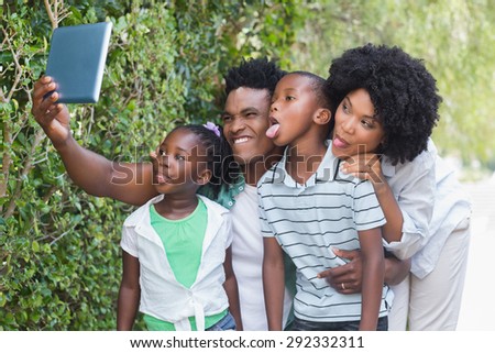 Happy family looking at tablet pc in the garden at home