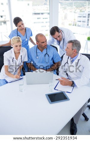 Team of doctors discussing during meeting in medical office