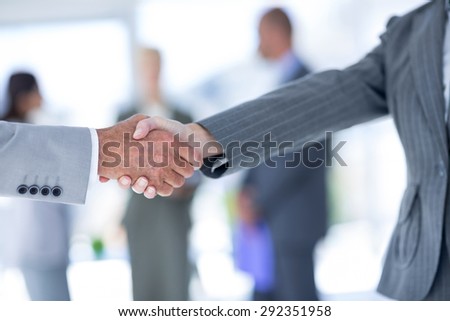 Businessman shaking hands with a co worker in an office
