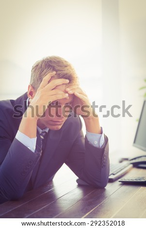 Irritated businessman looking his desk in the office