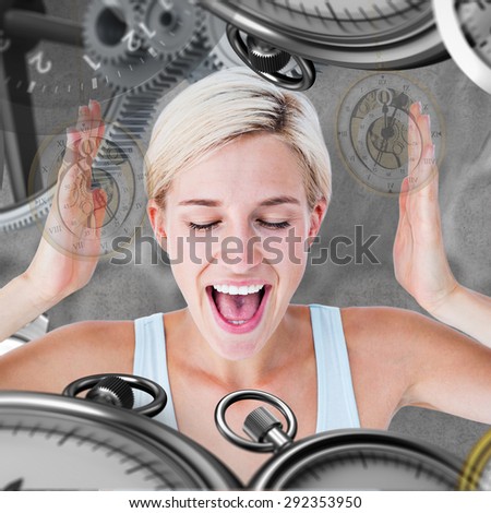 Happy blonde woman screaming with hands up against grey background