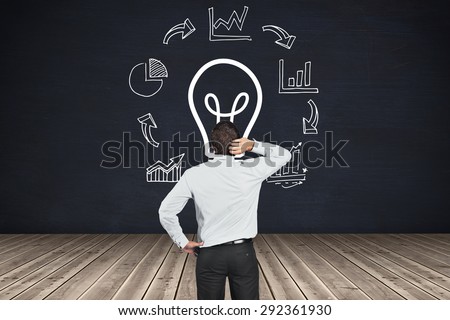 Thinking businessman scratching head against black room