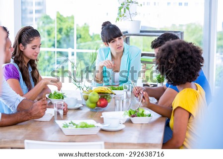 Group of friend eating together in living room