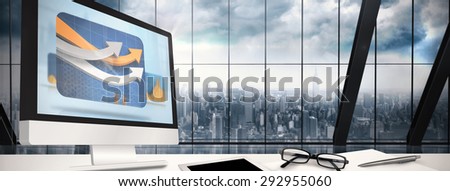 Computer screen against room with large window looking on city