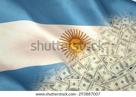 Pile of dollars against digitally generated argentinian national flag