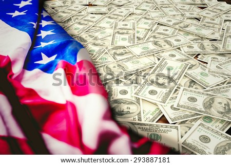 Pile of dollars against usa flag on table
