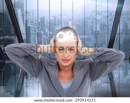 Close up of annoyed tradeswoman covering her ears against room with large window looking on city