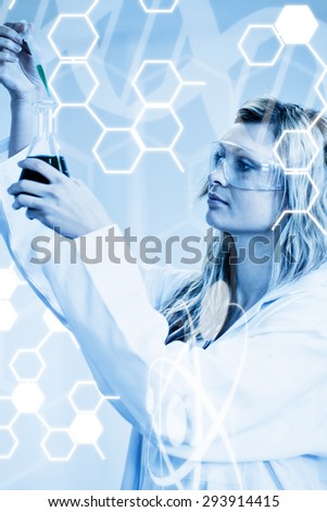 Science graphic against woman in lapcoat looking at chemicals