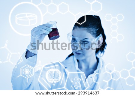 Science graphic against scientist looking at a red beaker
