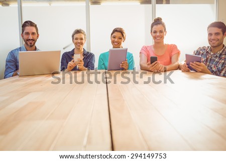 Young creative business people with laptop and digital tablet in the office