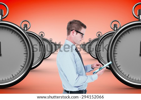 Handsome businessman using tablet against orange