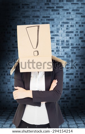 Businesswoman lifting box off head against dark grey room