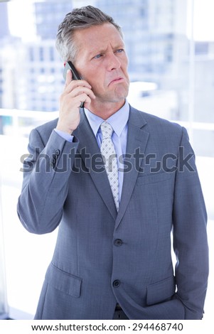 Angry businessman on the phone in the office