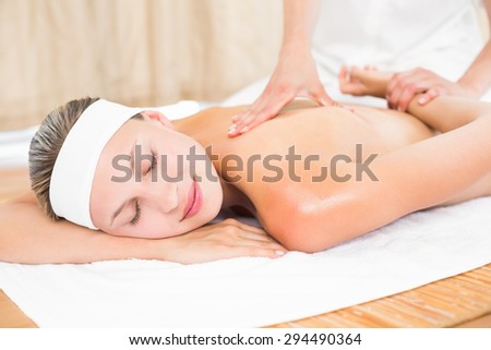 Blonde enjoying a back massage at the health spa