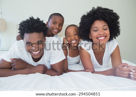 Happy family having fun together at home in bedroom