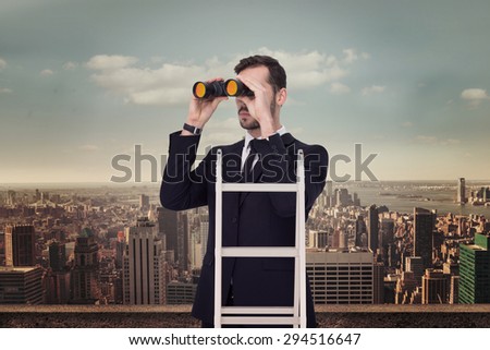 Businessman looking on a ladder against balcony overlooking city