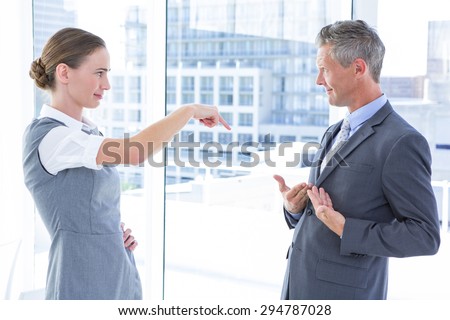 Business woman pointing her colleague in the office