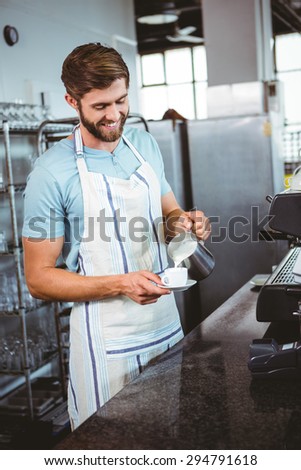 happy worker making coffee in the bakery