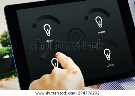 Man using tablet pc against home automation system