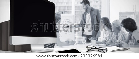 Computer screen against casual business people in office at presentation
