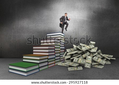 Cheerful businessman in a hurry against steps made from books in grey room