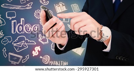 Businessman in glasses using his tablet pc against blue background