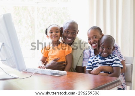 Portrait happy smiling family using computer at home