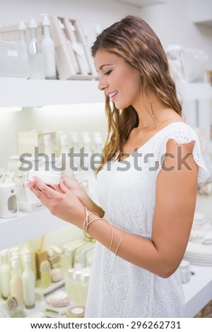 Smiling woman testing moisturizer at a beauty salon