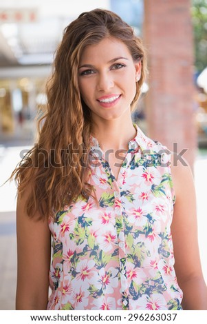 Portrait of smiling woman wearing blouse with floral pattern at the shopping mall