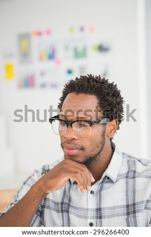 Young businessman thinking in his office