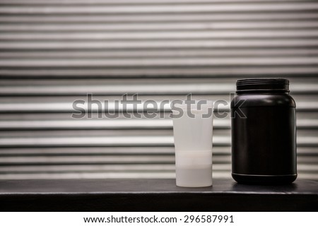 Protein powder drink and flask in crossfit gym