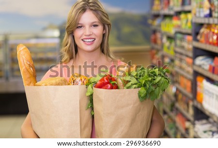 Portrait of a pretty blonde woman buying food products at supermarket