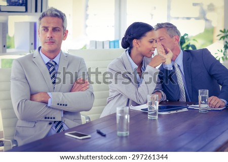 Sad businessman looking aways while his colleagues speaks in office