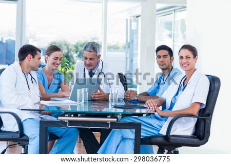 Team of smiling doctors having a meeting in the meeting room