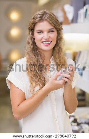 A pretty blonde woman in a perfumery at the mall