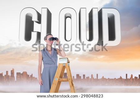 Businessman looking on a ladder against sandy path leading to large urban city