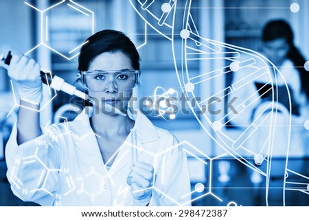 Serious chemist working with white dna helix diagram inteface against science graphic