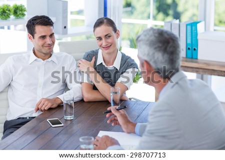 Casual business people speaking together in office
